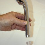 Water Widget fitted to handheld shower
